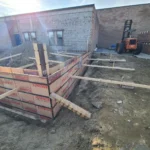 Construction site with foundation forms and forklift