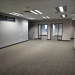 Empty office space with glass doors and windows.