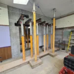 Construction site with support beams and tools.