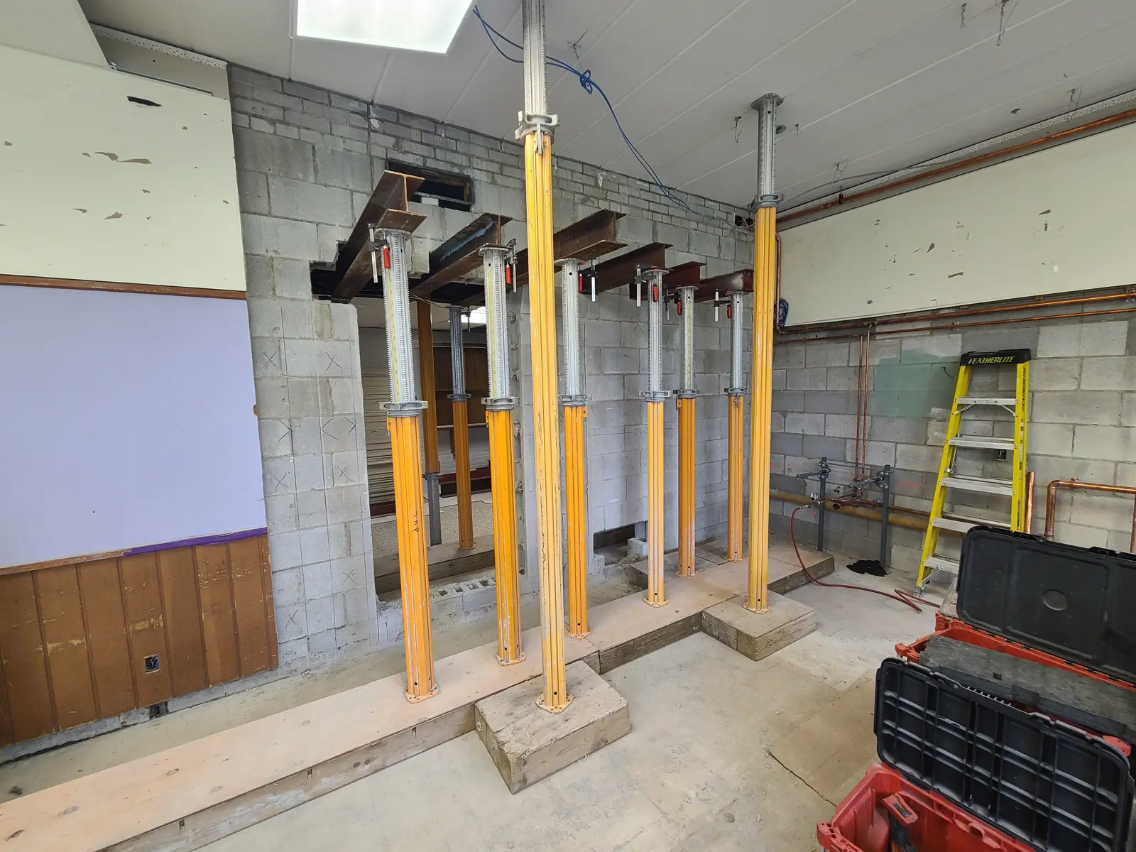 Construction site with support beams and tools.