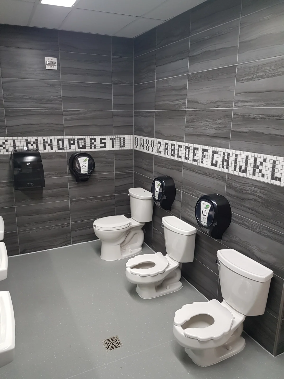 Restroom with standard and child-size toilets.