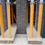 Temporary column support in building construction site.