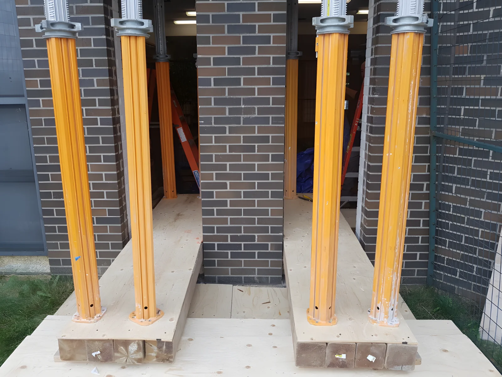 Temporary column support in building construction site.