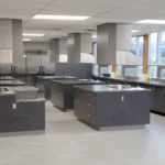 Modern commercial kitchen with stainless steel appliances.