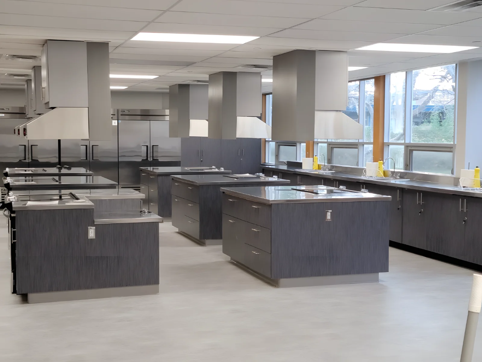 Modern commercial kitchen with stainless steel appliances.