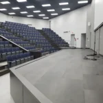 Empty modern lecture hall with tiered seating.
