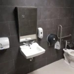 Accessible restroom with sink and toilet facilities.