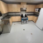 Modern kitchen with stainless steel appliances.