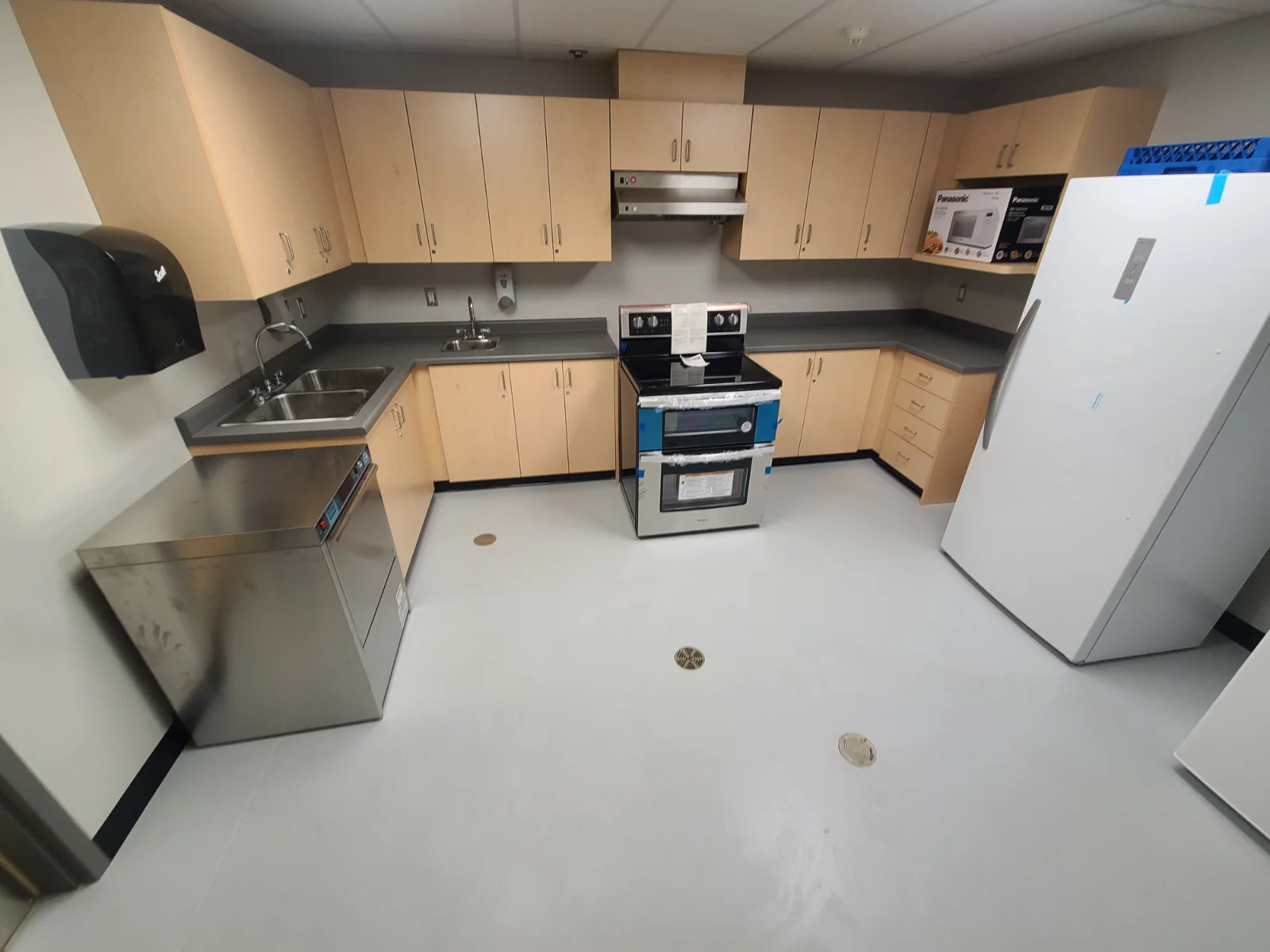 Modern kitchen with stainless steel appliances.