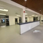 Empty hospital reception area with tiled floor.