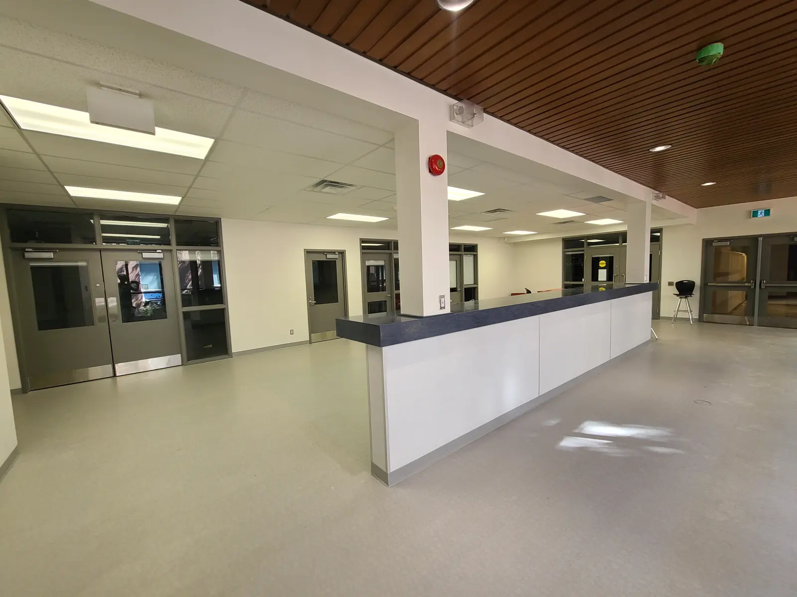 Empty hospital reception area with tiled floor.