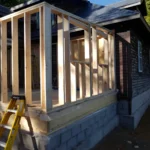 Home renovation with wooden framing and scaffolding.