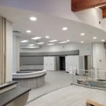 Modern reception area with curved desk and cabinets.