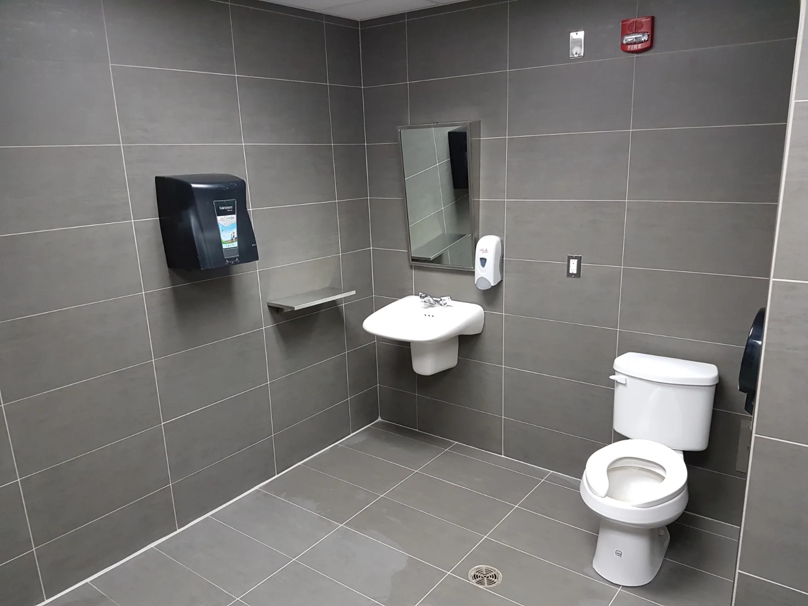 Modern accessible bathroom with sink and toilet.