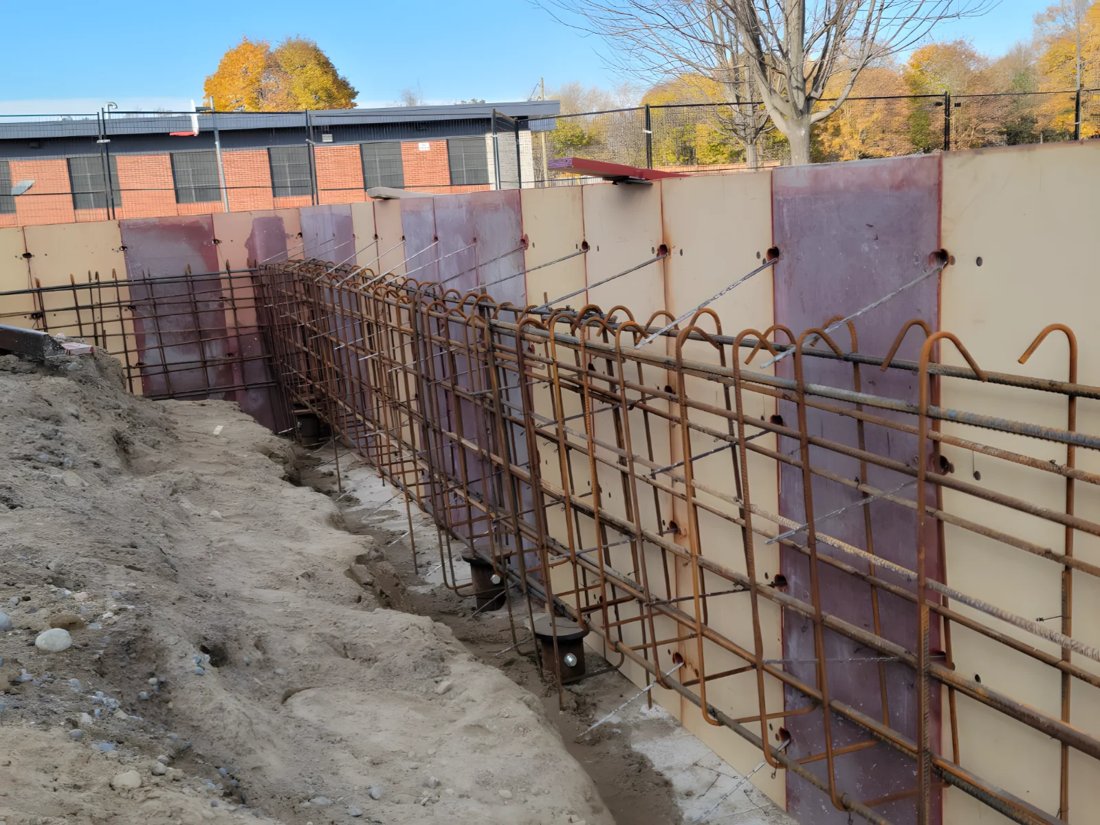 Reinforced concrete foundation with metal rebar framework.