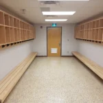 Empty locker room with benches and cubbies.