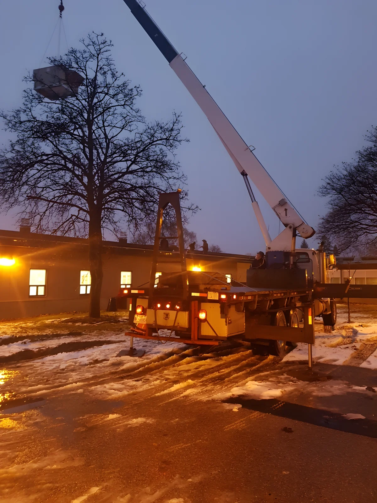 Crane lifting equipment at snowy construction site