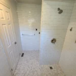 Modern bathroom with white tiles and shower head