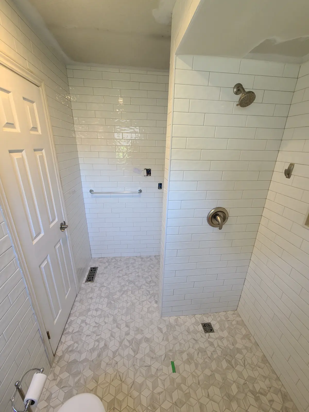 Modern bathroom with white tiles and shower head